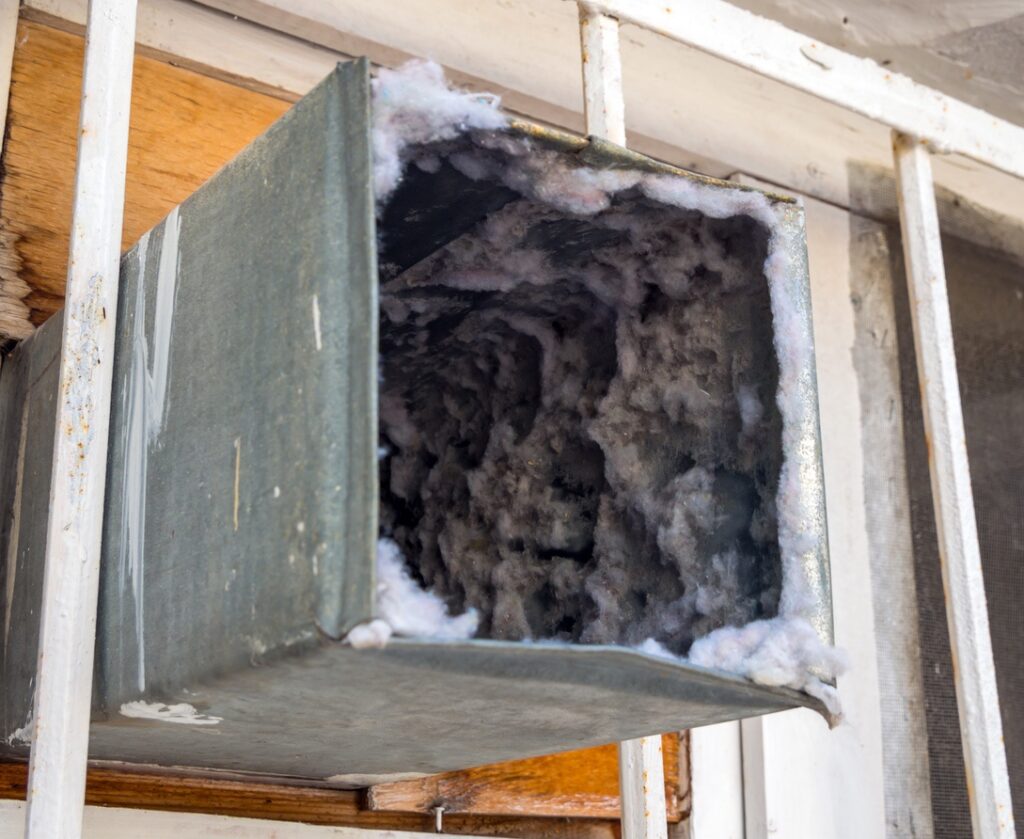 Dirty residential air duct with visible debris inside