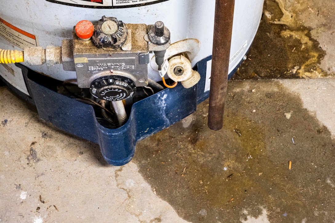 Leaking water near base of hot water heater tank