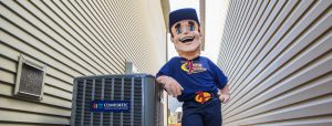 Action Furnace Mascot leans his elbow against newly installed A/C unit
