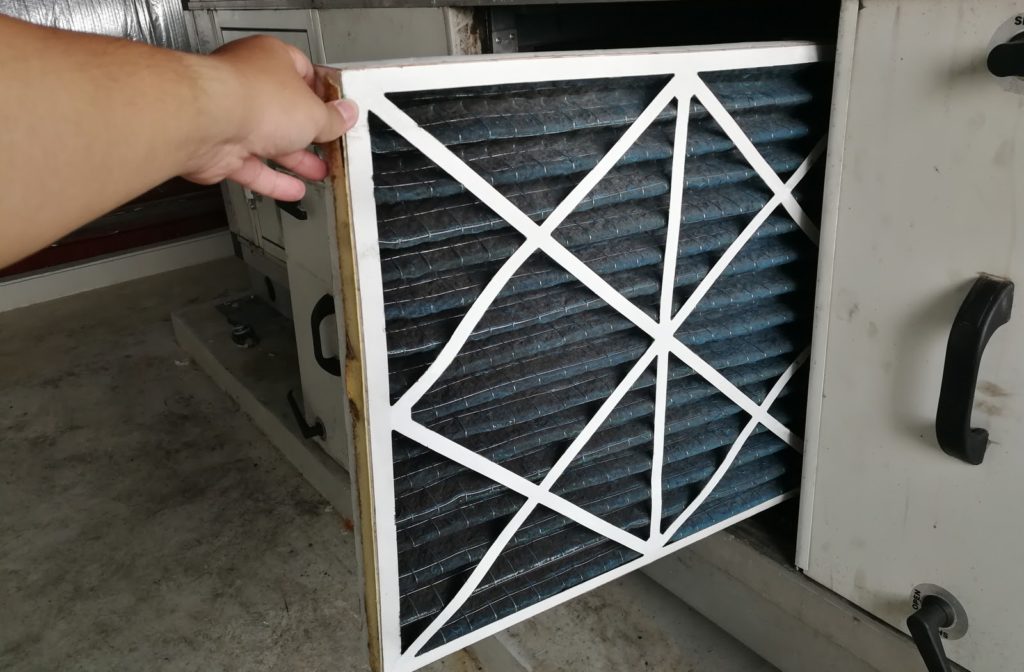 Technician inspects a furnace filter