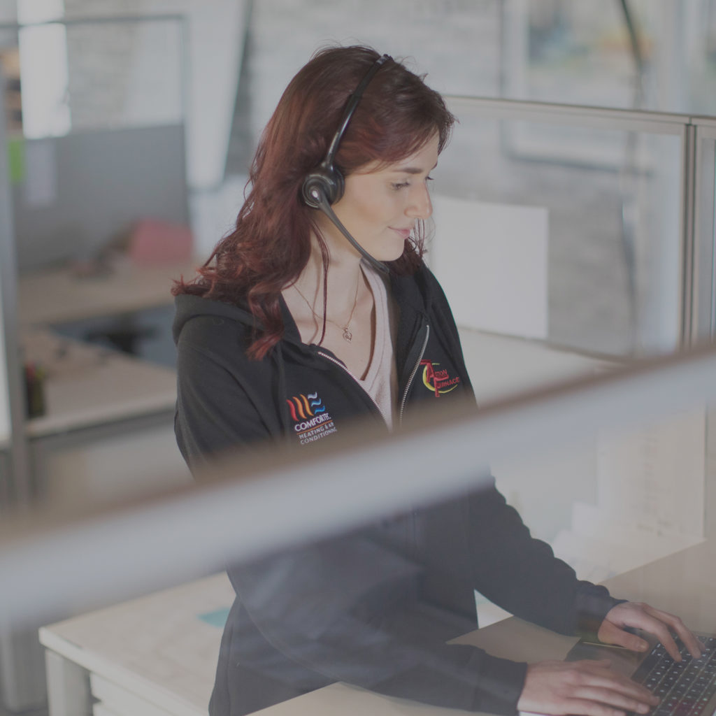 Customer service representative typing at keyboard.