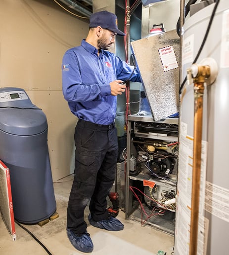 Technician inspecting customer's furnace