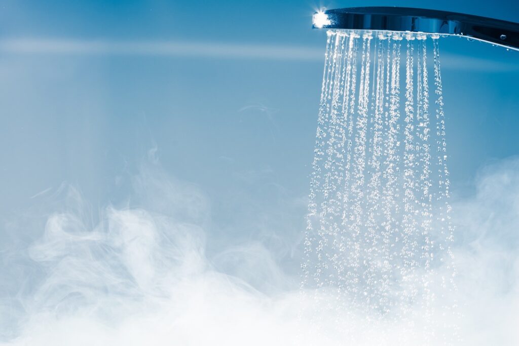 Reducing static by adding moisture to indoor air with hot shower water