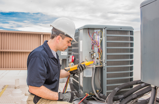 Professional technician working on AC units in residential home.