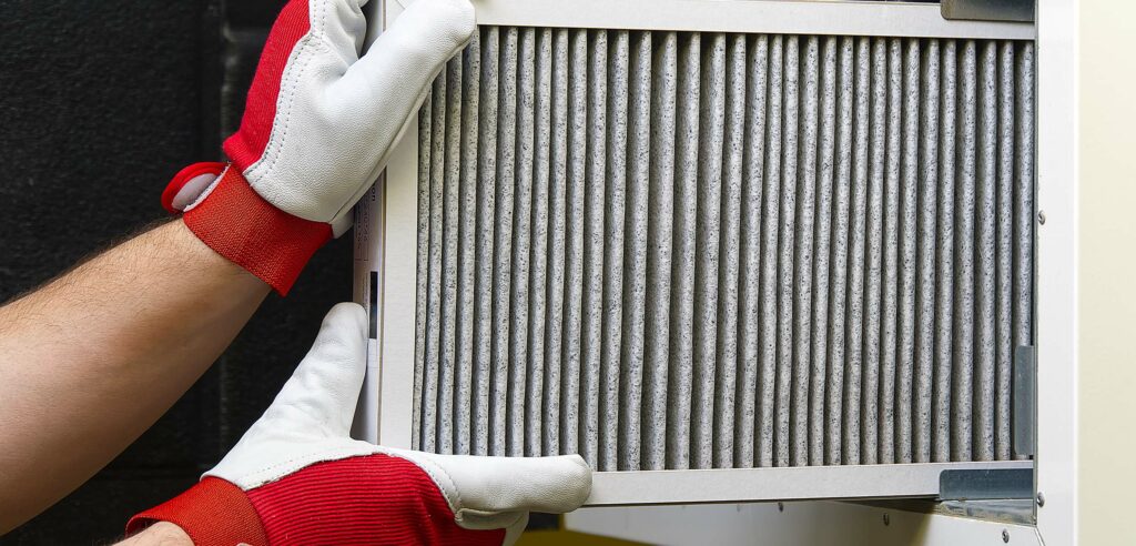 Technician installing furnace filter