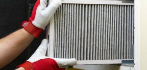 Technician removing dirty furnace filter