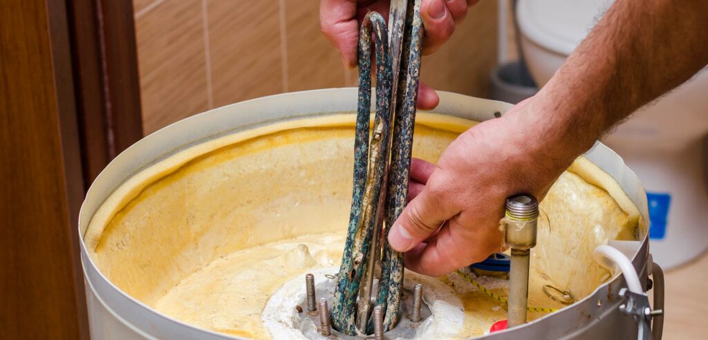 Corroded copper pipes in an old water heater - Water heater maintenance