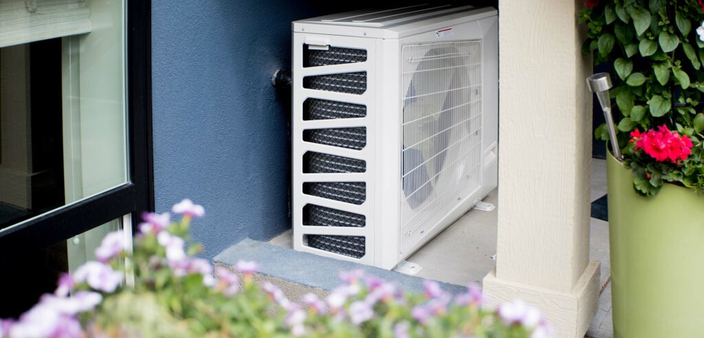 Air filtration unit mounted outside home.