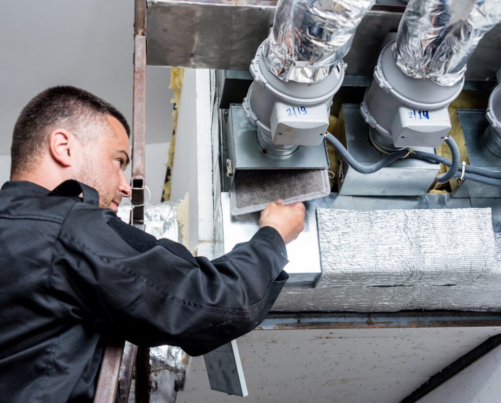 HVAC technician cleaning ducts