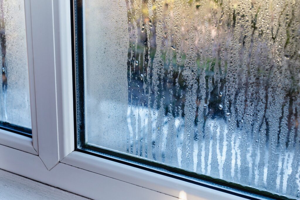 Humidity inside Alberta home in summer demonstrated by condensation on window surface