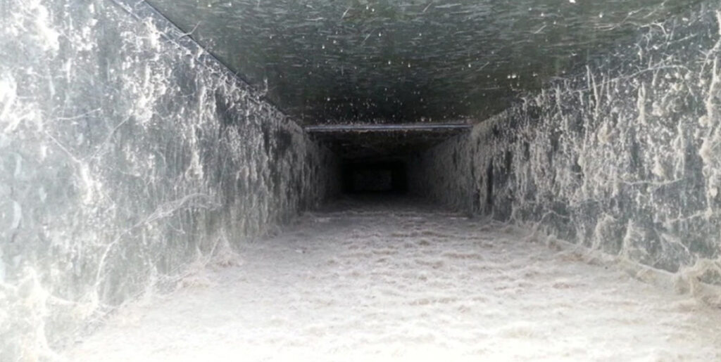 Inside of a filthy air duct.