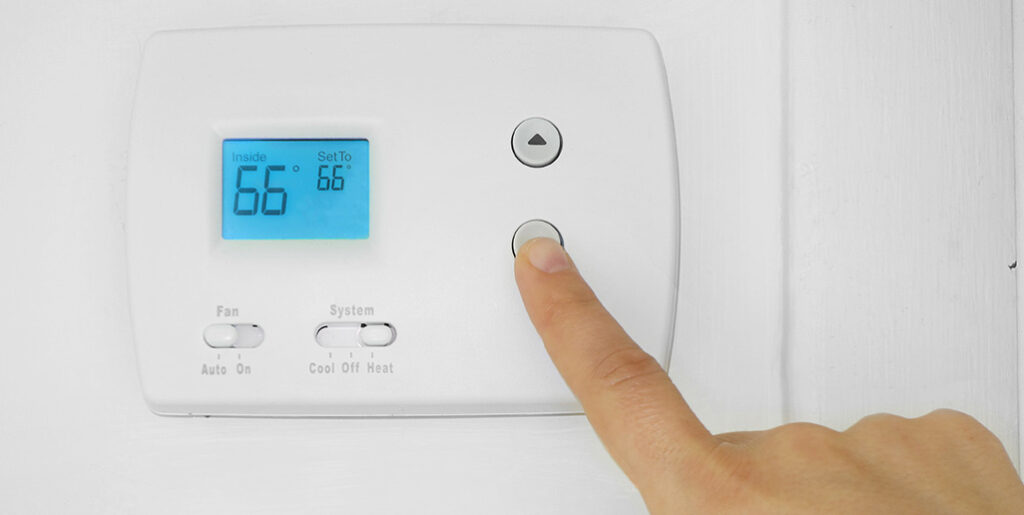 Hand setting thermostat to 66 degrees F.