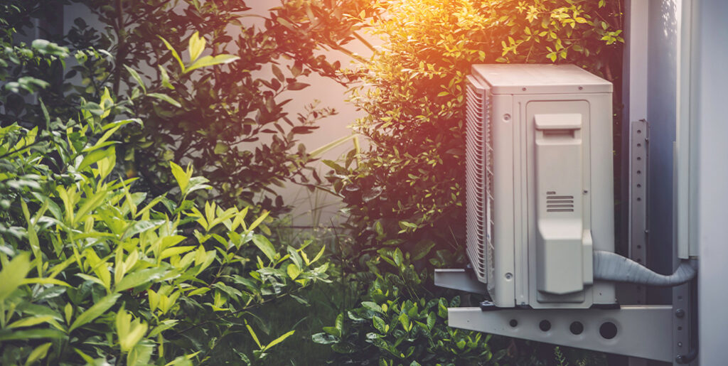 AC unit surrounded by shrubs