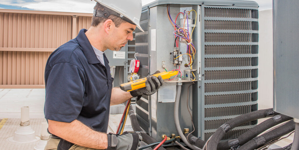 Technician repairing AC unit