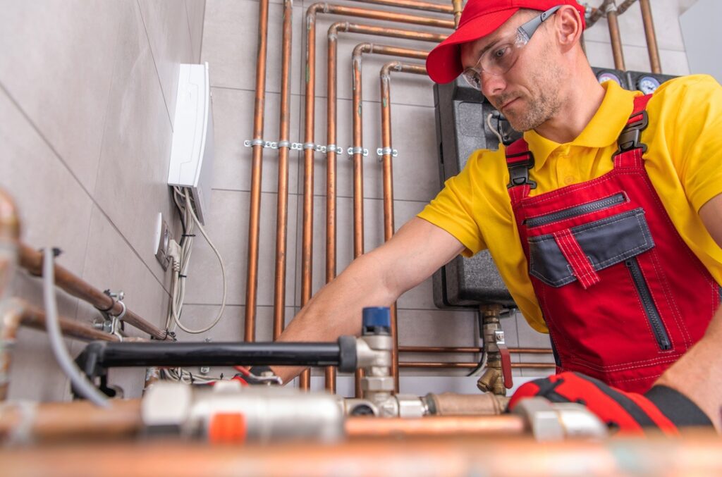 HVAC technician working on high-efficiency natural gas furnace in home