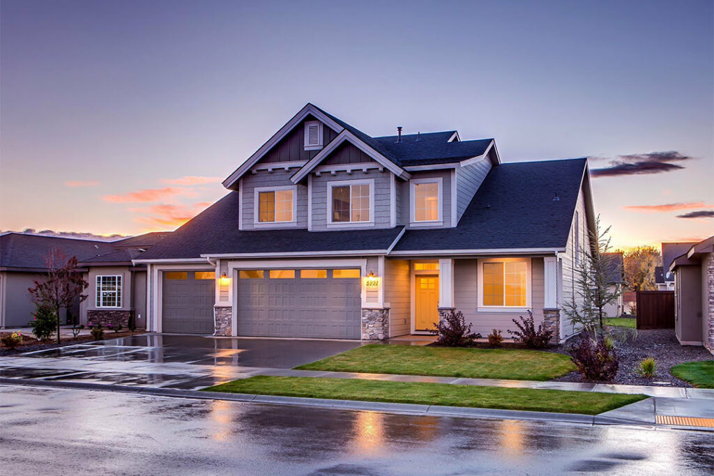 Well lit suburban home at sunset.