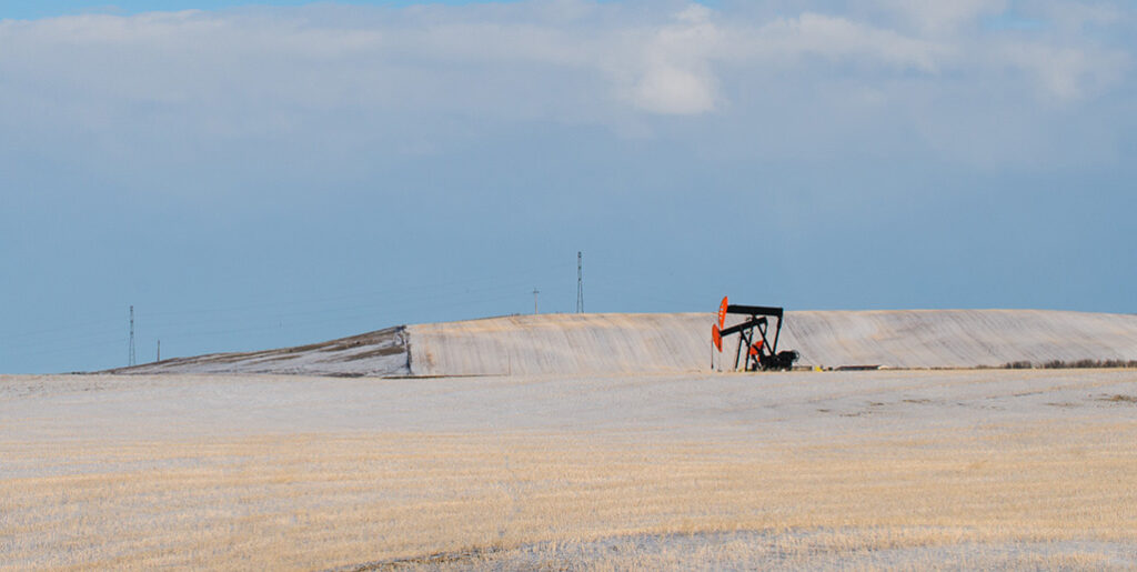 Oil derrick in flat empty field