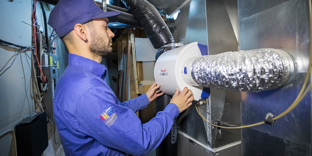 HVAC technician inspecting electric furnace