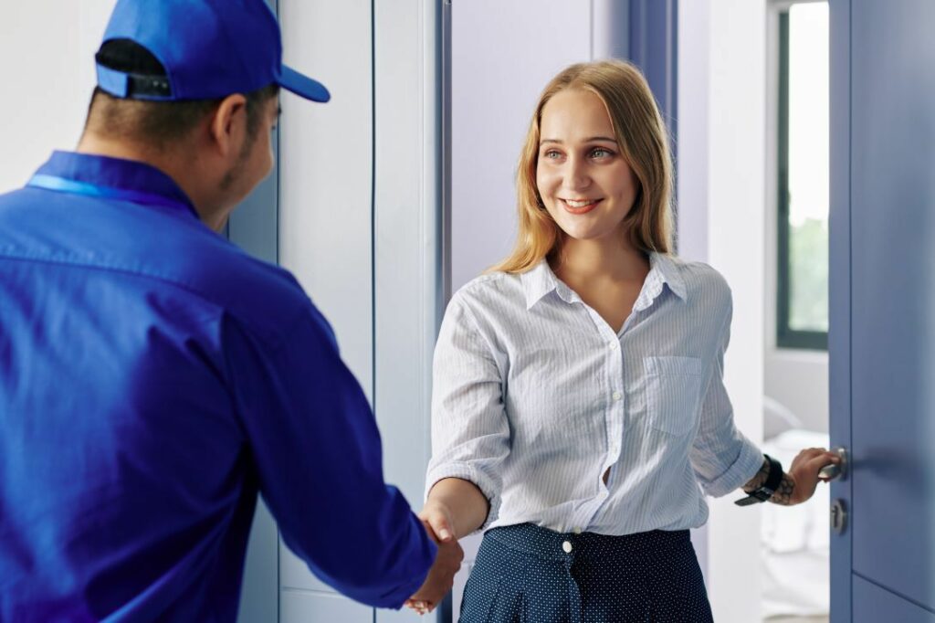 Technician and woman shaking hands