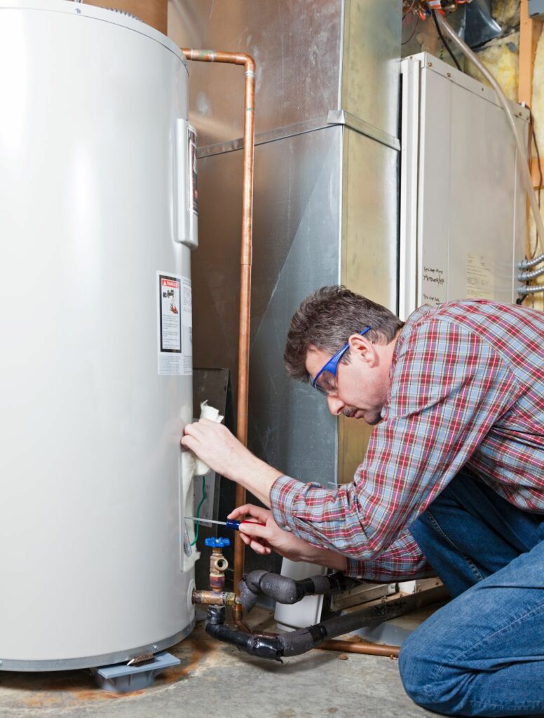 Technician working on hot water tank