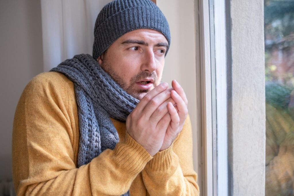 One man feeling cold at home after home heating trouble