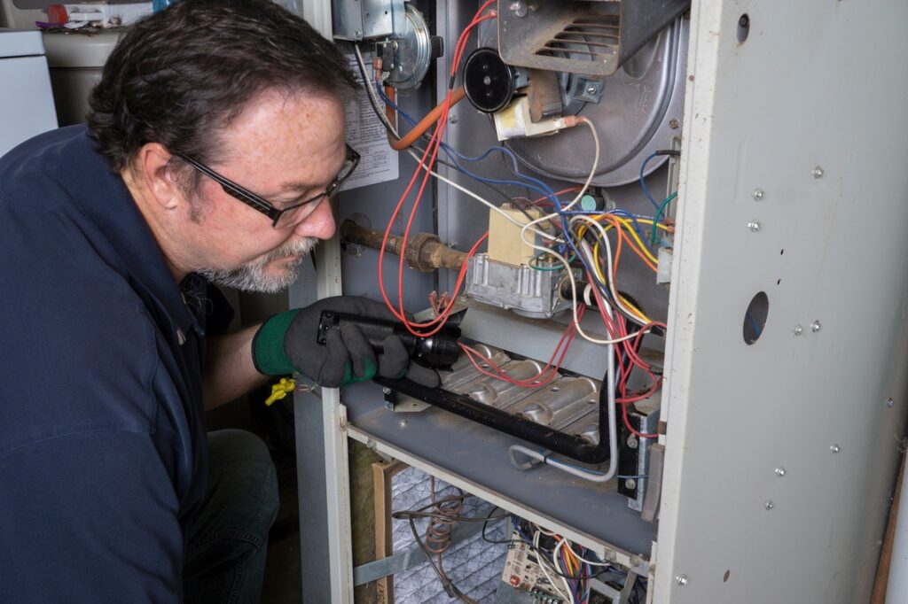 HVAC technician checking home furnace