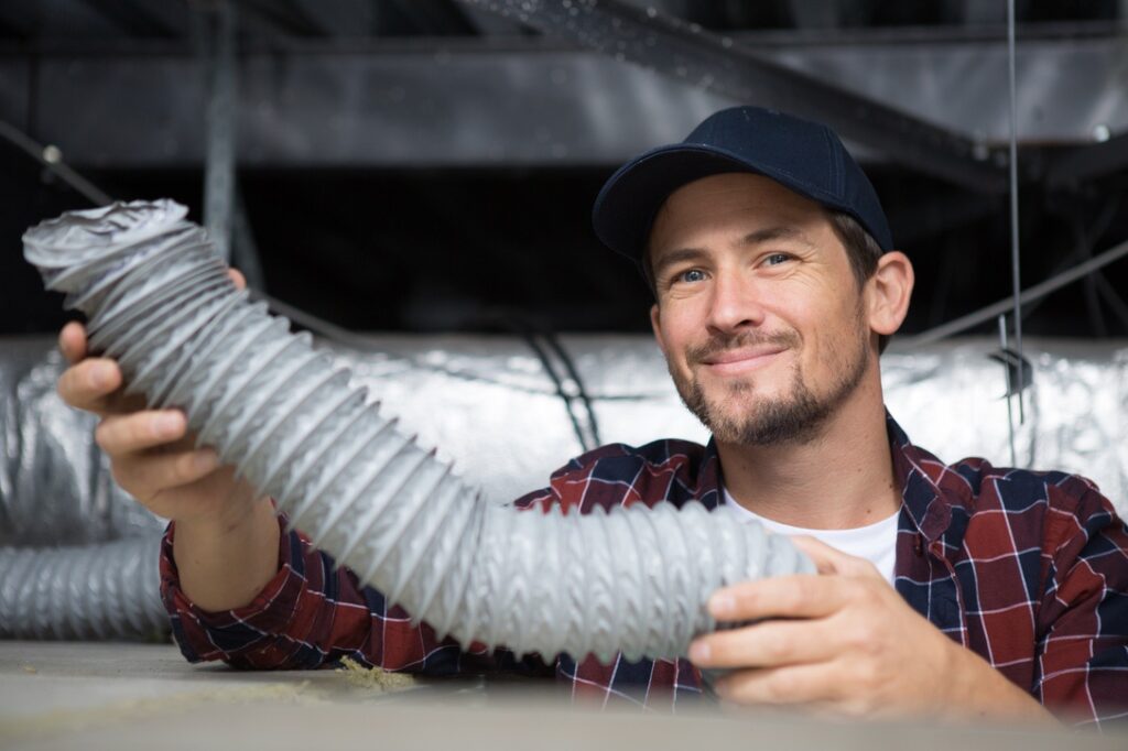 hvac technician ready to install ventilation system in house