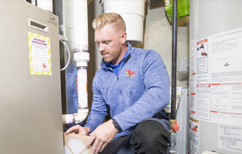 Action Furnace furnace technician inspecting a filter