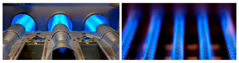 Closeup of inside a home natural gas furnace showing blue jets of fossil fuel burning.

Burning of natural gas in water heater furnace blue flame.