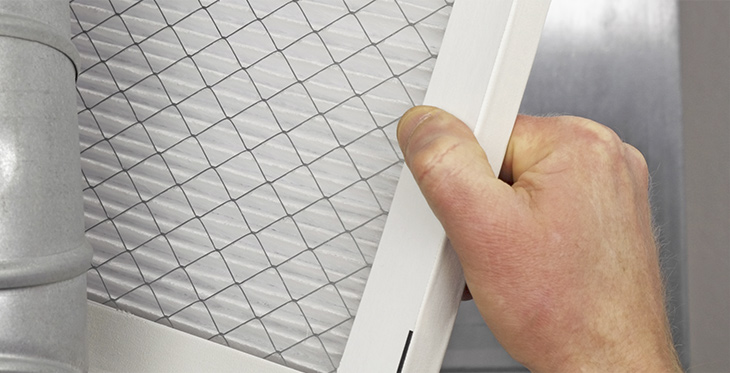 Man installing new air filter