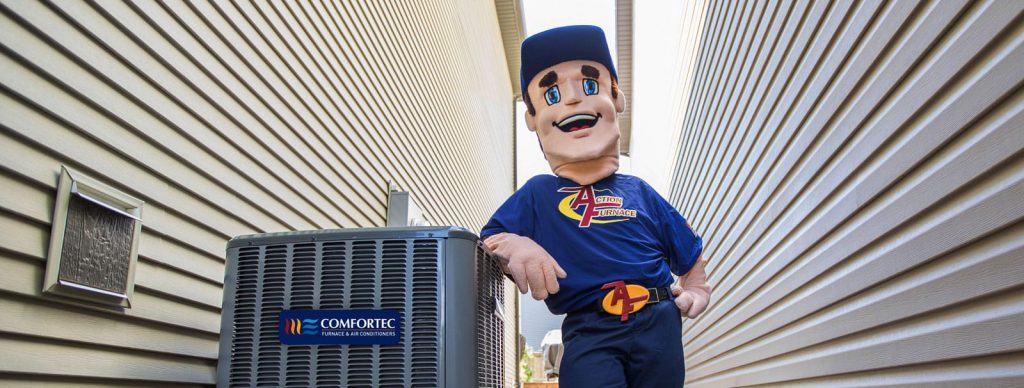 Preparing Your Central Air Conditioner For Winter Action Furnace Mascot leans his elbow against newly installed A/C unit