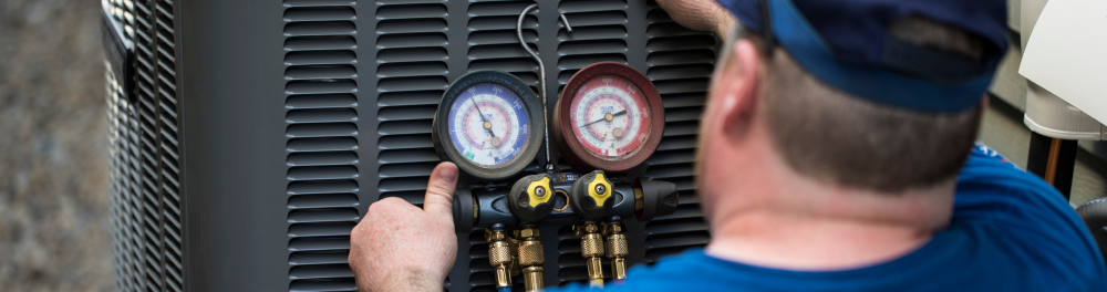 An Action Furnace technician runs a diagnostic check on a central air conditioner.