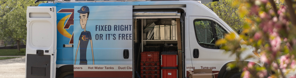 An Action Furnace van parked outside a job. The doors of the van are open showing that it is fully stocked with all the technician needs to complete the appointment.
