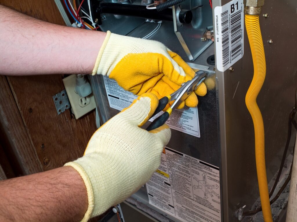 Furnace technician inspecting furnace