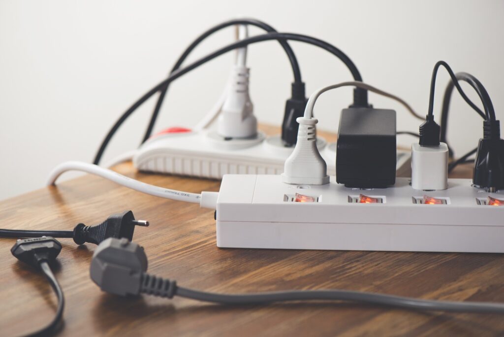 Many plugs connected to the power strip with individual switches.