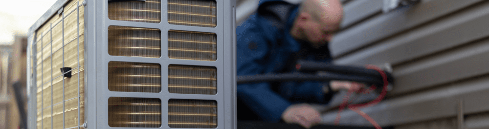 A close up image of a brand new heat pump being installed by an Action Furnace technician. 