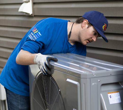 An Action Furnace technician carefully selects the installation location for a heat pump.