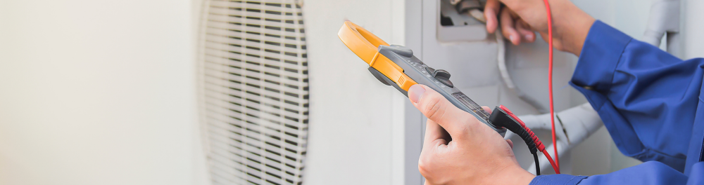 An Action Furnace Technician runs diagnostics on a residential air conditioner.