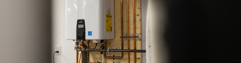 A tankless water heater installed in a residential mechanical room