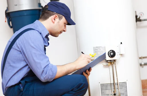 Normal vs. Abnormal Water Heater Noises Plumber repairing water heater with abnormal noises
