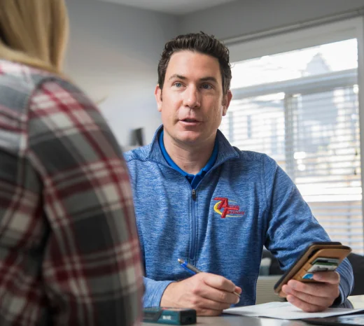An Action Furnace Home Comfort Advisor talks through his air conditioner equipment recommendations with a homeowner.
