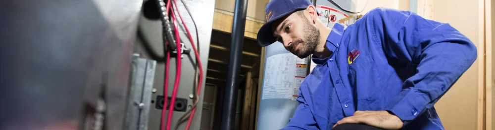 An Action Furnace technician inspects a newly installed furnace to ensure quality workmanship.